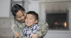 Son being hugged by his mom from military