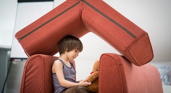 Kid playing on his small house