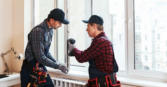 Two construction worker working on the window