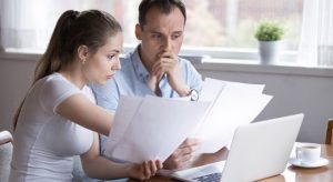 Two professionals; man and woman, looked stress while looking at a paper
