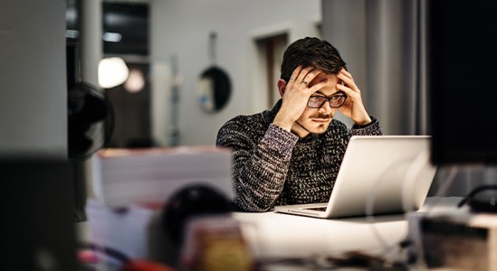 Man looking stress while using laptop