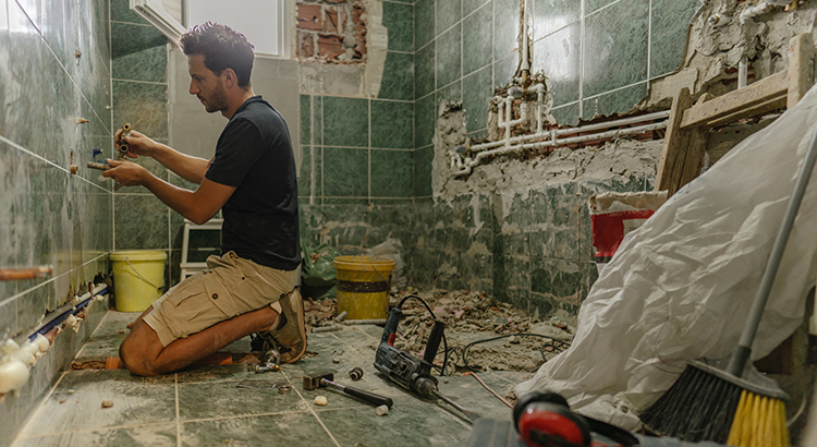 Young man renovating bathroom by himself