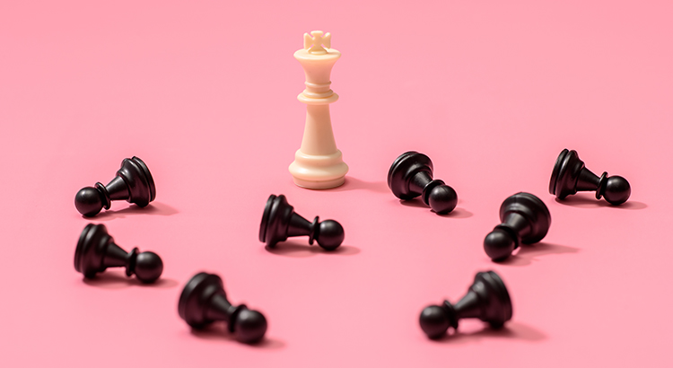 Chess piece of King and the fallen pawn on pink background