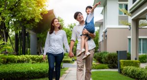 Asian family, mother, father and daughter walking together