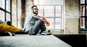 Casual business person sitting in office loft
