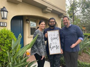 Richard Wamsat with Couple Client in front of their new home.