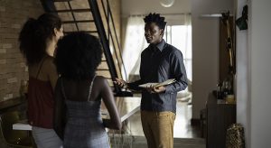 Real estate agent showing a property to applicants