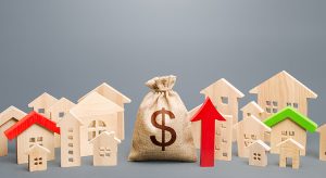 Dollar money bag with model houses from both sides