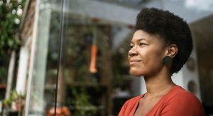 Woman staring outside of her home