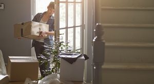 Woman carrying box to her home