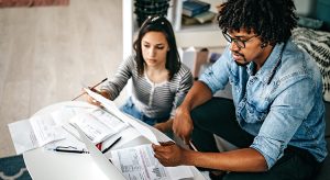 Couple planning budget over laptop at home