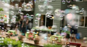 Bubbles floating in front of suburban house