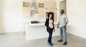 Couple standing in kitchen in new house