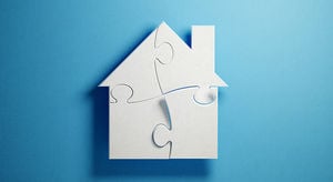 Puzzle Concept - White Jigsaw Puzzle Pieces Forming A House Shape On Blue Background