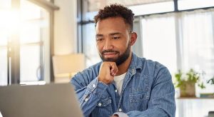 Man on his computer thinking deeply