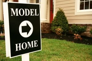Model home sign - the person who is at the model home is working for the builder.