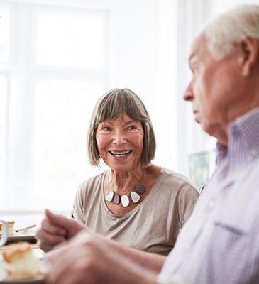 Retired couple having lunch together at home