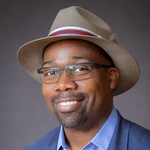 Abraham Walker, Northern Virginia REALTOR®, smiling in a blue blazer and hat