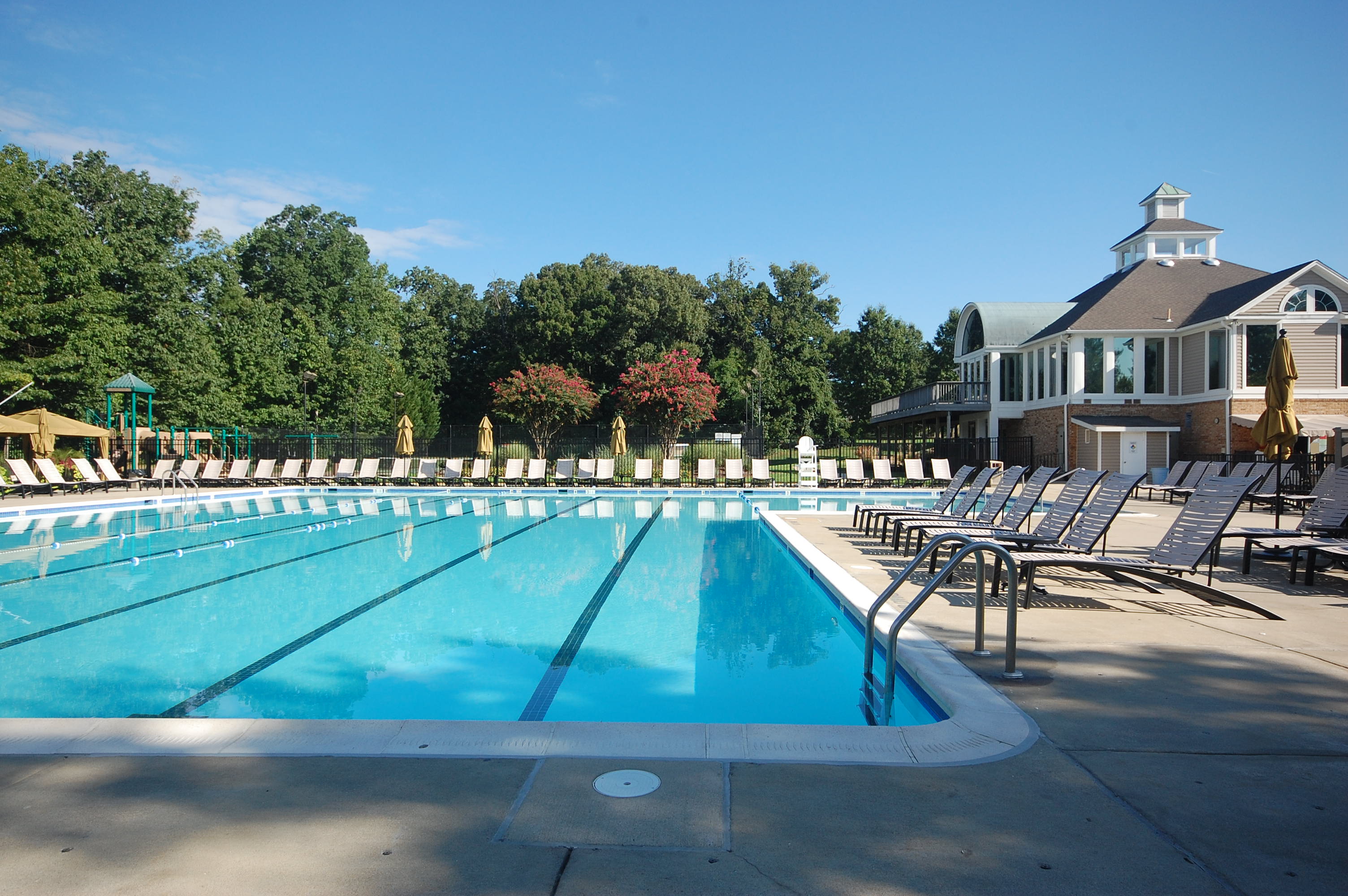 Kingstowne community swimming pool with clubhouse and lounge chairs