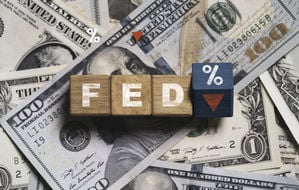FED wording with down arrow and percentage sign on USD dollar banknote for Federal reserve decrease interest rate control which effect to America and world economic growth concept.