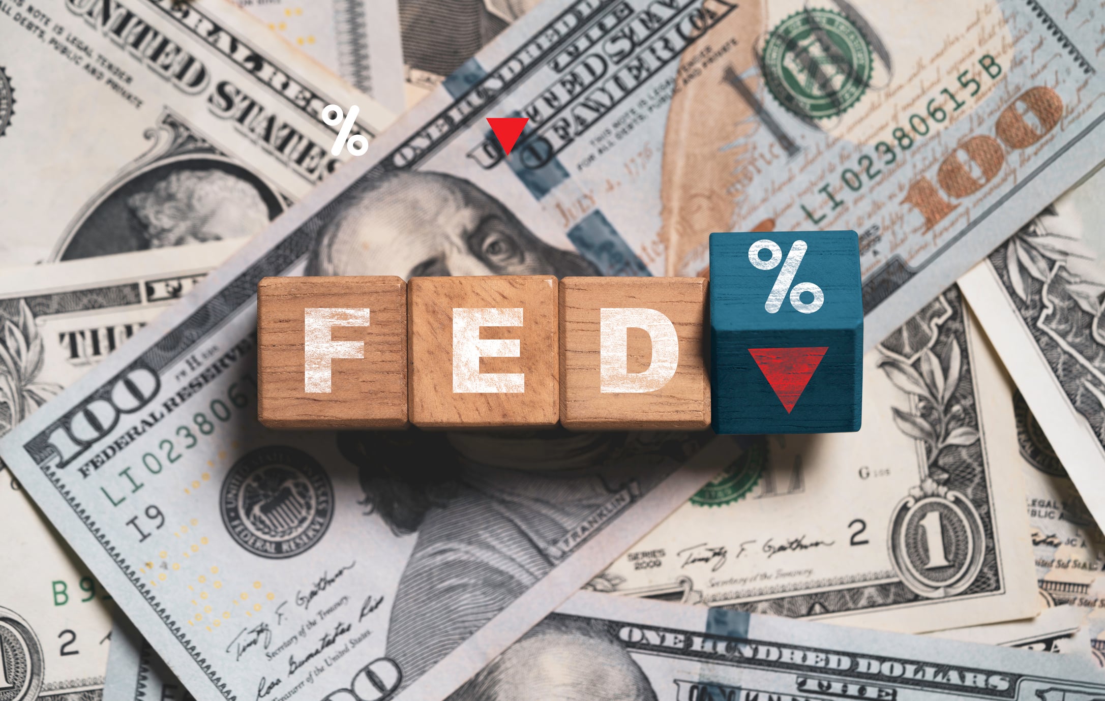 FED wording with down arrow and percentage sign on USD dollar banknote for Federal reserve decrease interest rate control which effect to America and world economic growth concept.