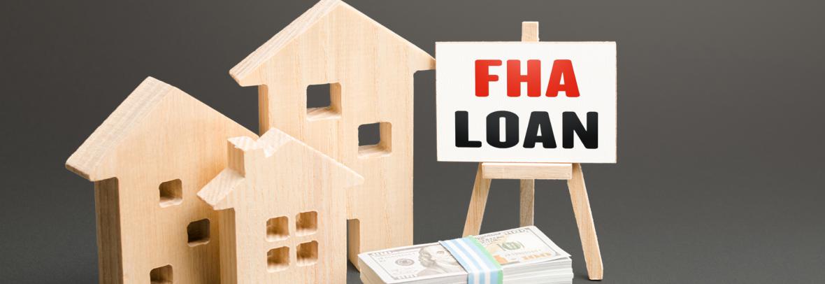 Stack of Fake Money, FHA Loan Sign and Carved wood houses