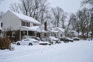 Houses with Parked Cars Covered in Snow