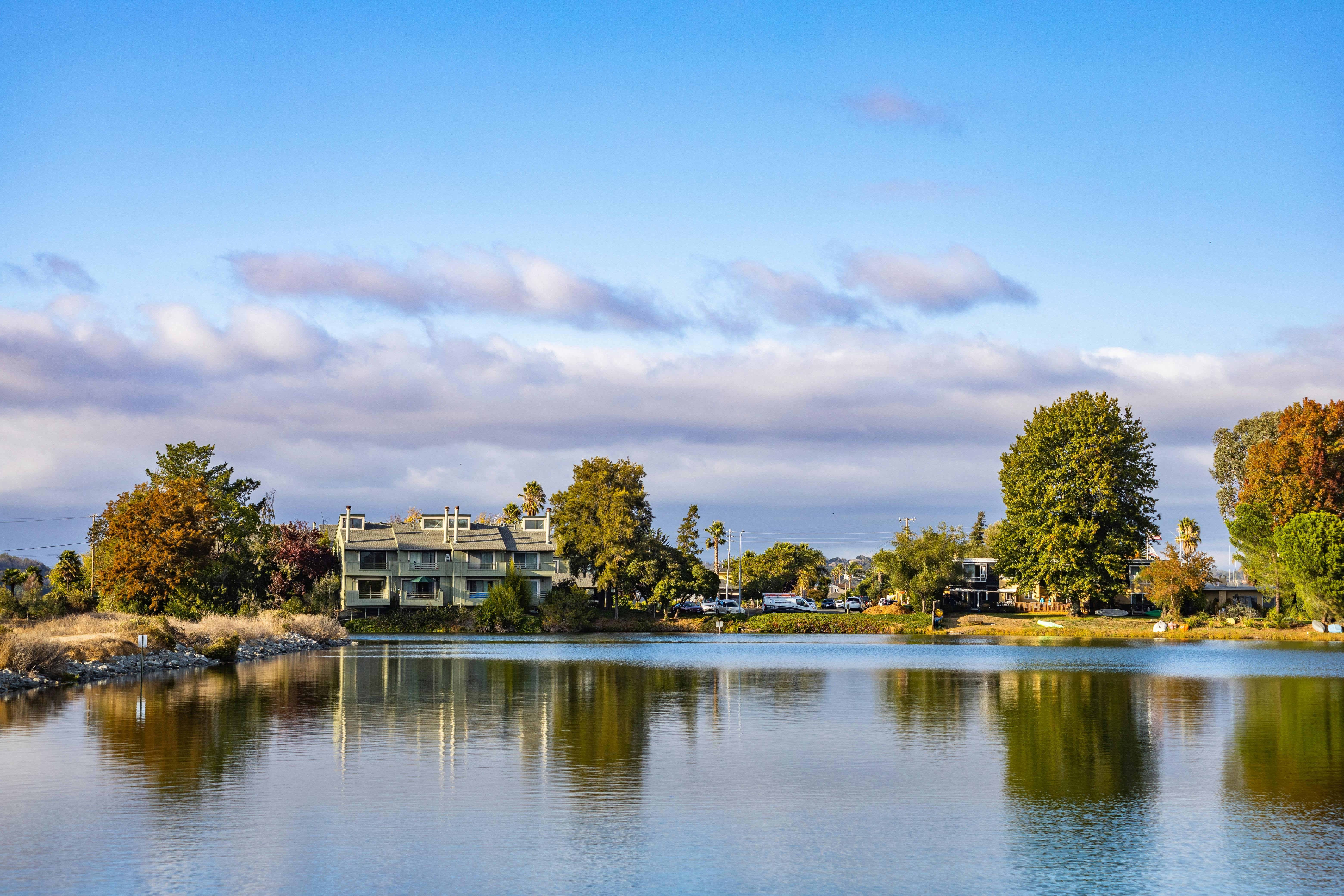 Beautiful House Surrounded with Green Trees Near the Lake