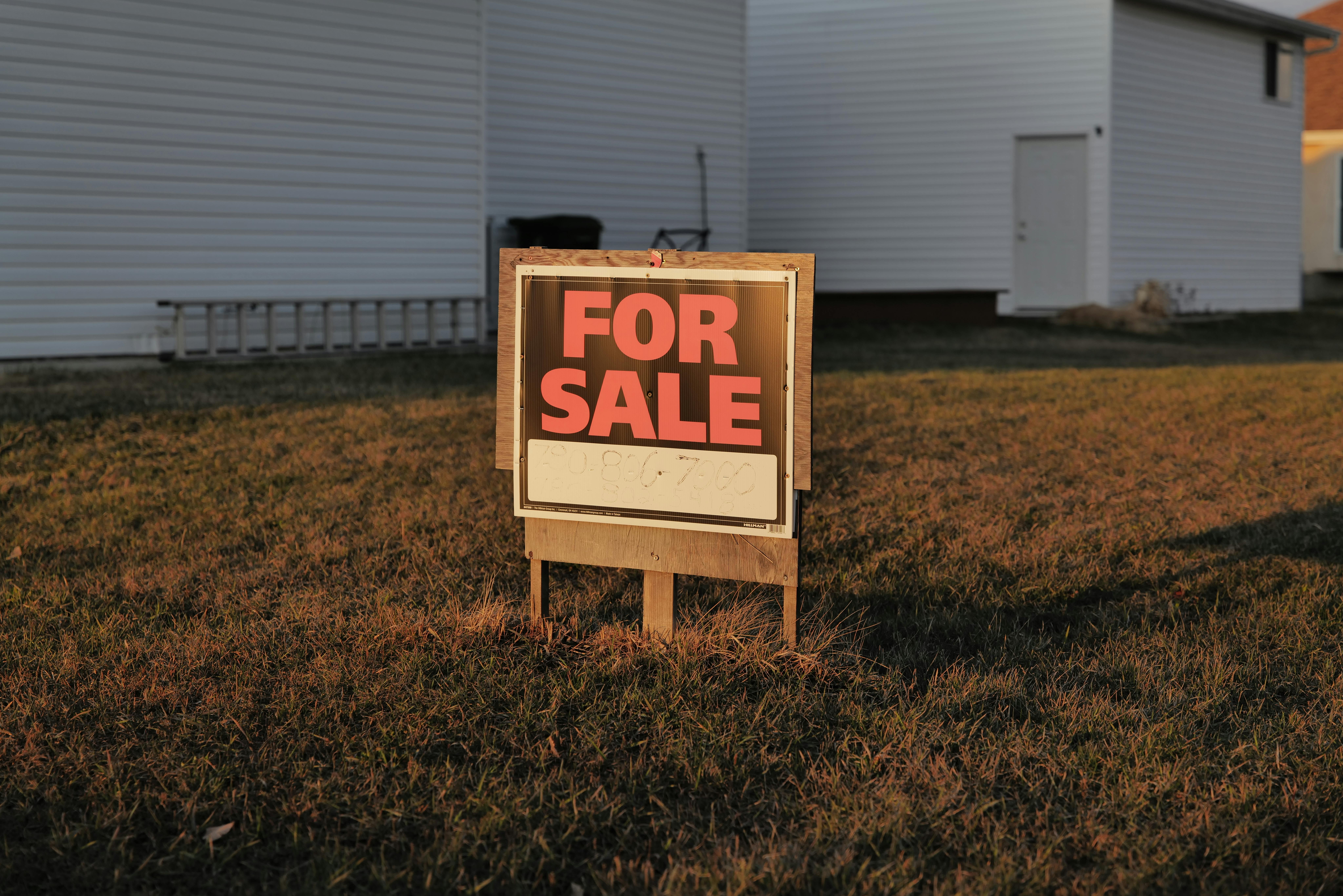 Real Estate For Sale Sign in Suburban Yard
