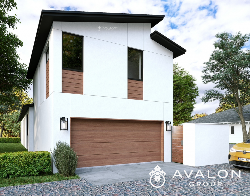 Rear elevation of a modern home on a narrow lot. The home is white stucco with black trim and wood garage doors.