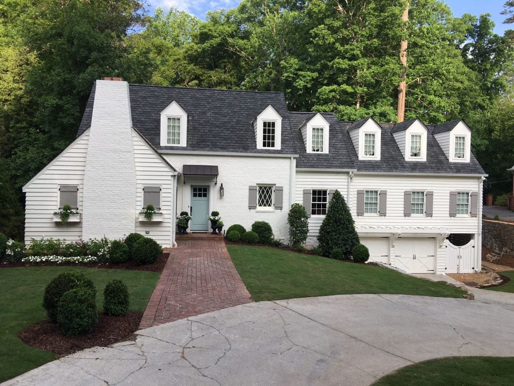 Williamsburg style home with dormer windows painted in Sherman Williams Alabaster paint color.
