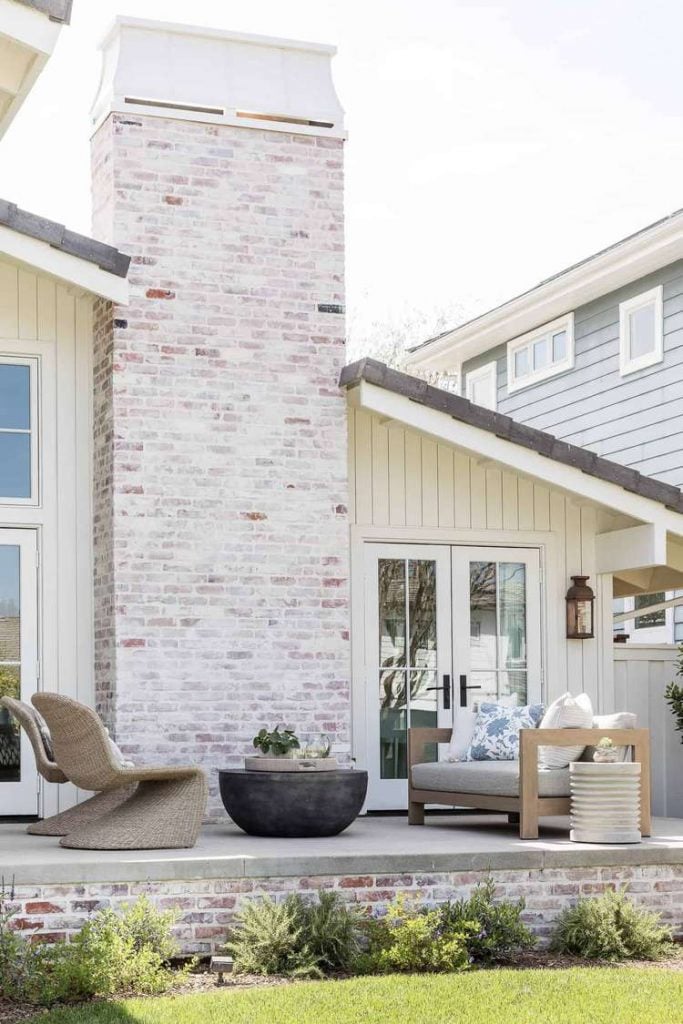 2023 White Paint Colors Swiss Coffee siding mixed with stone. This home color is perfectly warm and inviting.