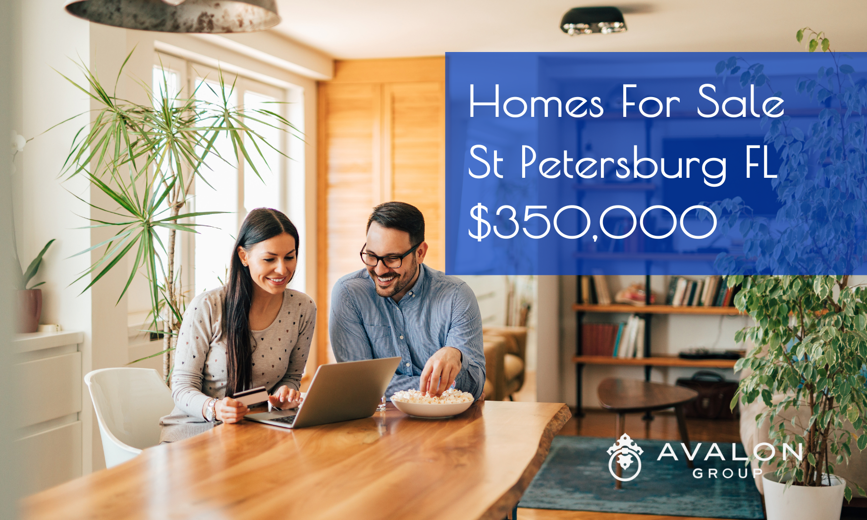 Homes For Sale St Petersburg Cover Pictures shows a married couple in a kitchen looking at a laptop.
