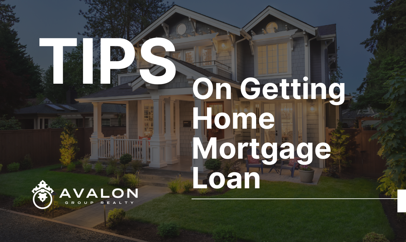 Tips On Getting Home Mortgage Loan cover picture shows a traditional 2 story home at dusk with the lights on inside.