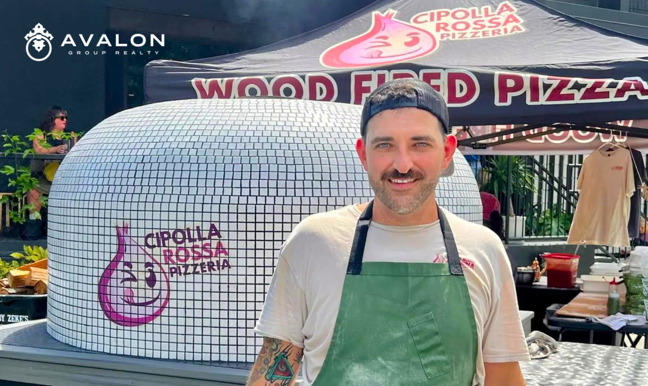 Cipolla Rossa Pizzeria A Rising Star in St. Pete's Pizza Scene picture shows the owner , Josh, wearing a green apron in front of the white tiled pizza oven.