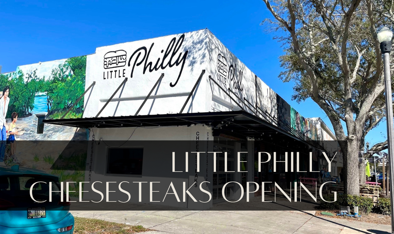 Little Philly Cheesesteaks Opening cover picture shows the store with white brick and black lettering, and the sky is blue.