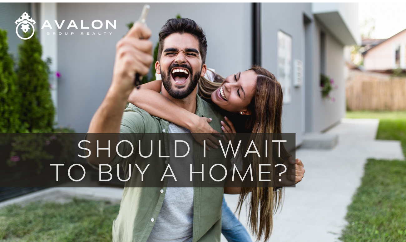 Should I Wait To Buy A Home? cover picture shows a young man and woman celebrating the buying of a home.
