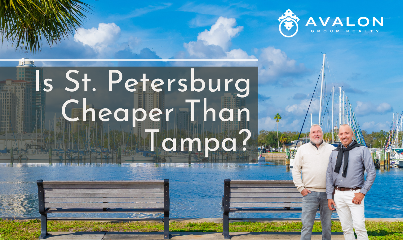 Is St. Petersburg Cheaper Than Tampa picture shows Rob and Aaron in front of two benches in a park overlooking the marina in St. Petersburg. The high rises can be seen in the distance.