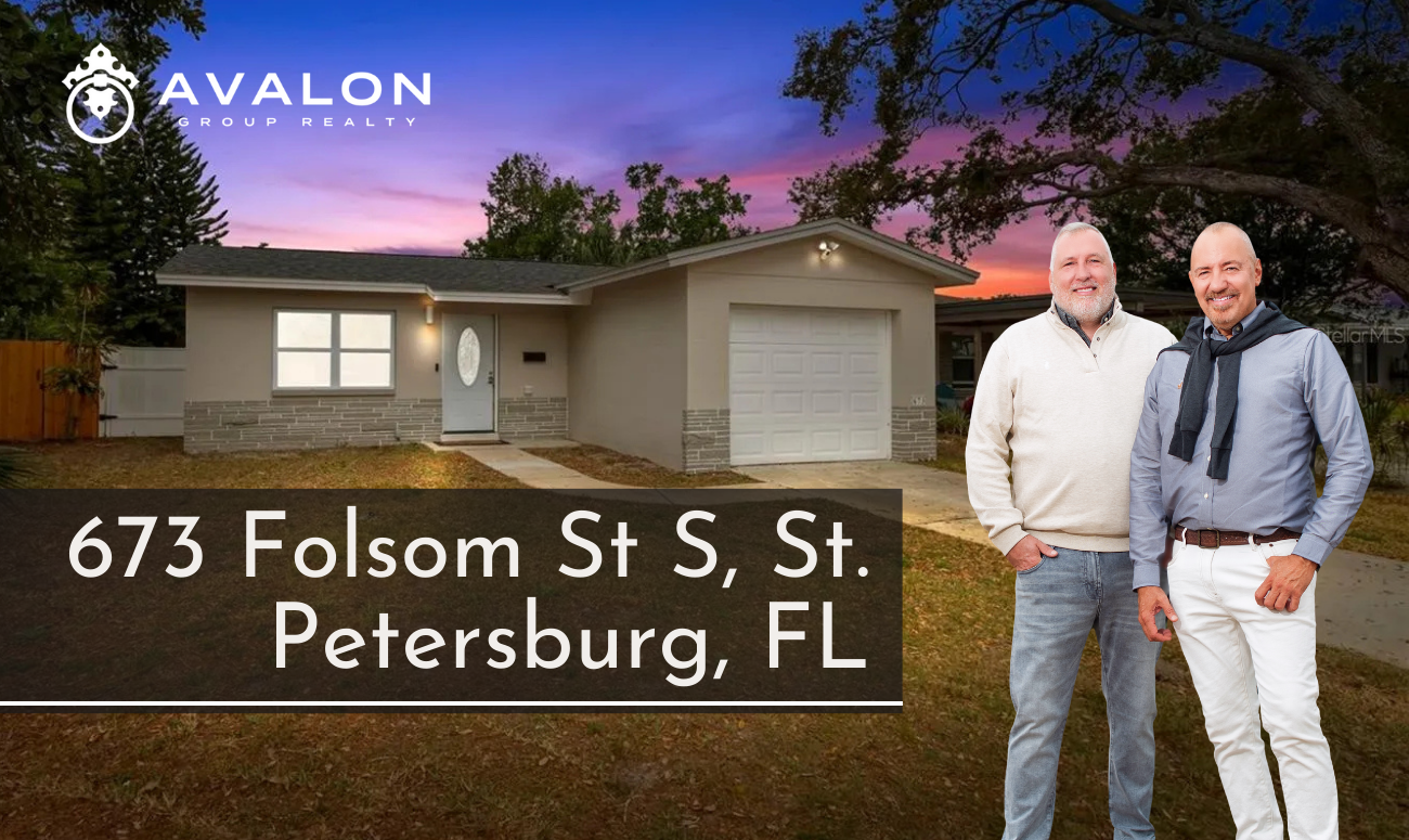 673 Folsom St S, St. Petersburg, FL picture show a picture of a grey stucco home with a pink and blue sky at sunset.