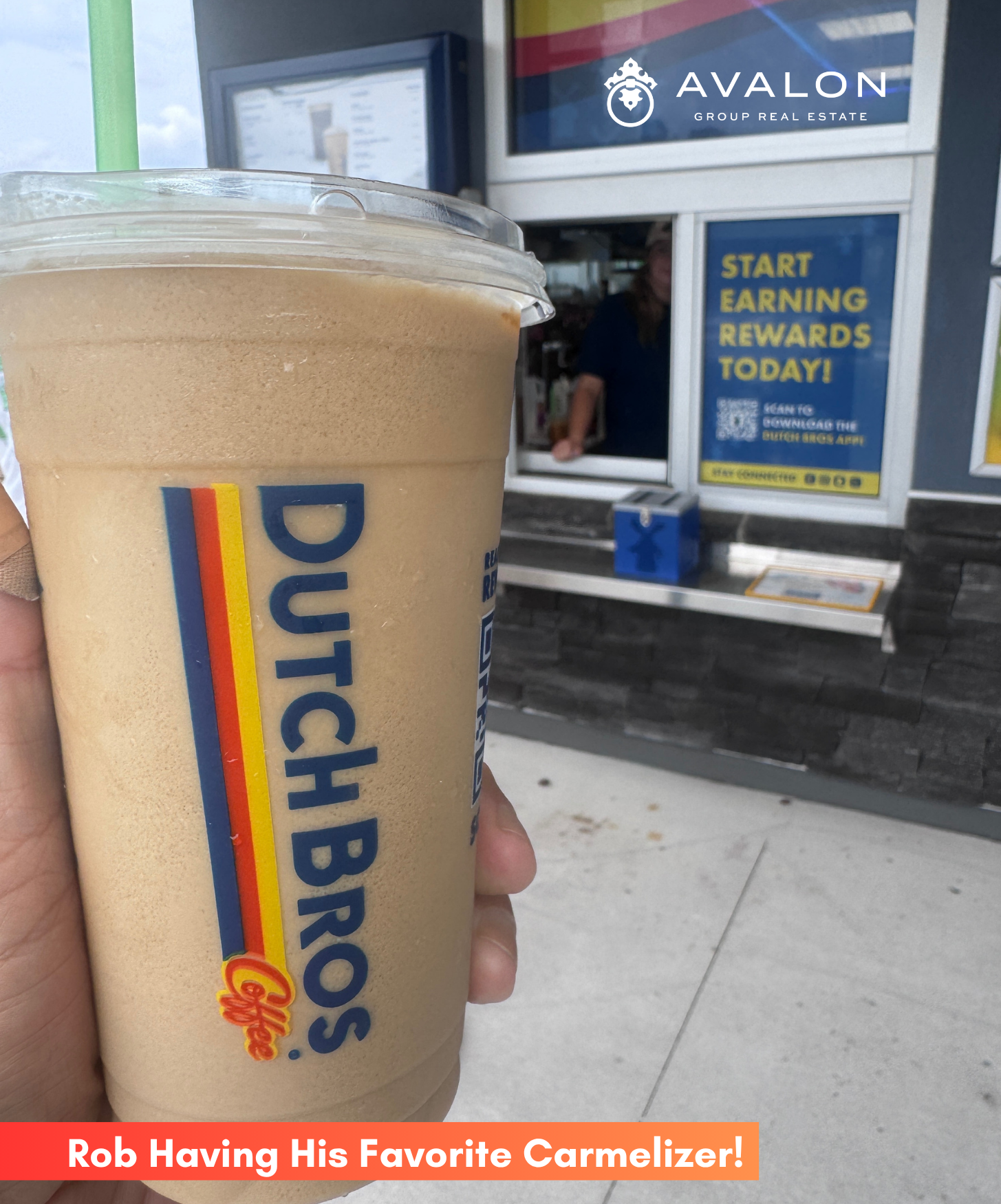 Dutch Bros Carmelizer picture shows a hand holding the blended frozen drink in front of the pick up window.