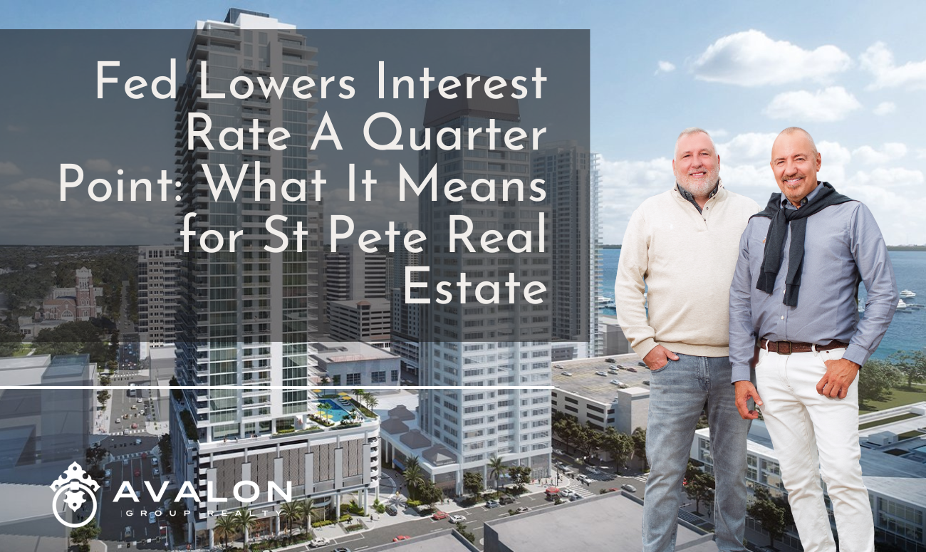 Fed Lowers Interest Rate A Quarter Point What It Means for St Pete Real Estate cover picture shows Rob and Aaron in front of a picture of downtown St Petersburg FL