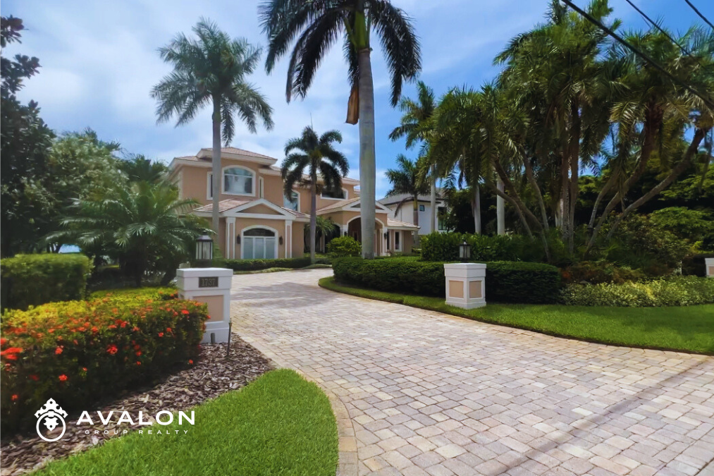 Snell Isle Home is a beige stucco Mediterranean style home with a paver driveway.
