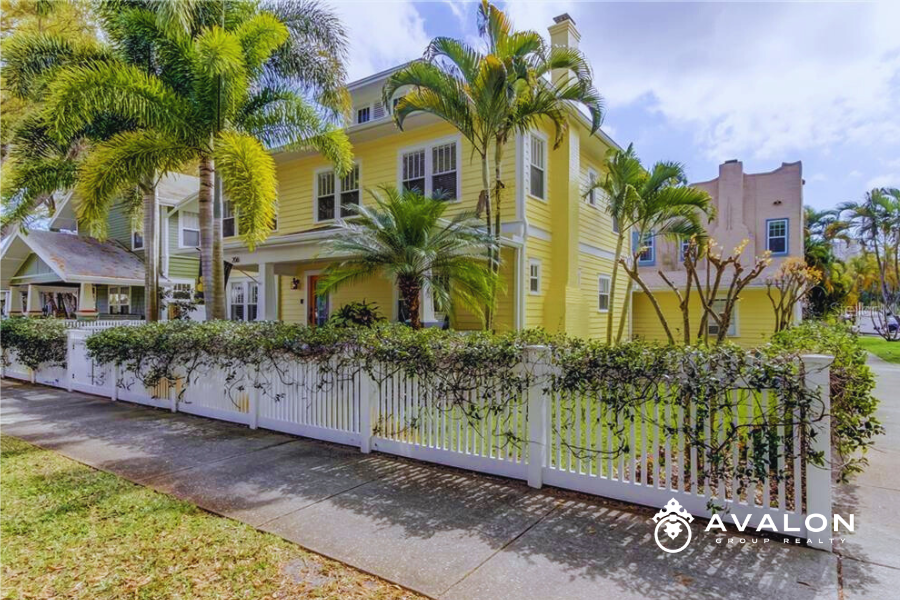 Historic Home Ownership in Kenwood & Old Northeast picture shows a historic yellow home with a white picket fence.