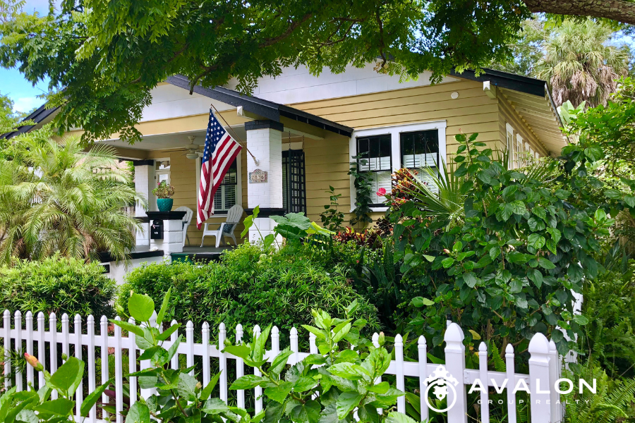 Best Neighborhoods in St Petersburg FL for 2026 Local Realtor’s Updated Guide Kenwood Historic Bungalow home is pictured with yellow siding, white trim, and a white picket fence.
