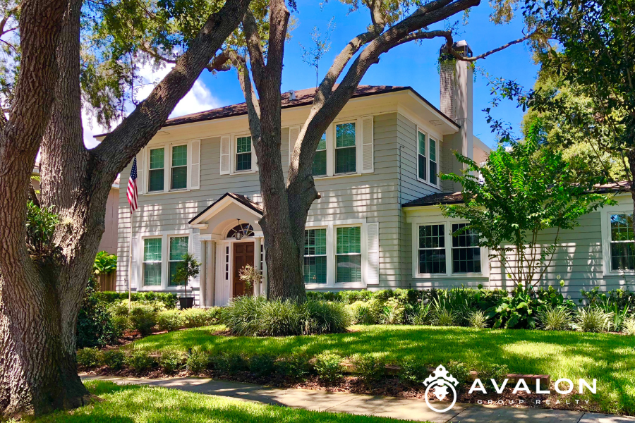 Best Neighborhoods in St Petersburg FL for 2026 Local Realtor’s Updated Guide Old Northeast picture shows a historic home with beige siding and white trim. The yard is well manicured with formal hedges.
