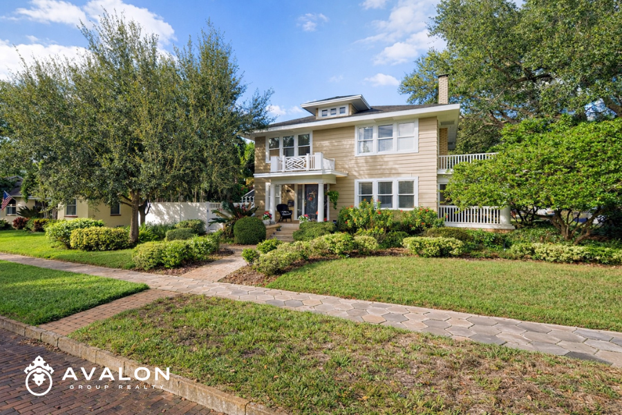 Traditional two-story home in the Euclid neighborhood of St. Petersburg FL featuring mature trees, landscaped yard, and classic architectural details.