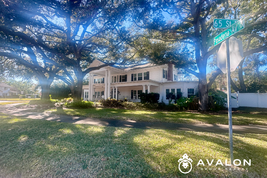 Historic two-story home shaded by mature oak trees at Pasadena Avenue and 65th Street in the Pasadena Lakes neighborhood of St. Petersburg Florida