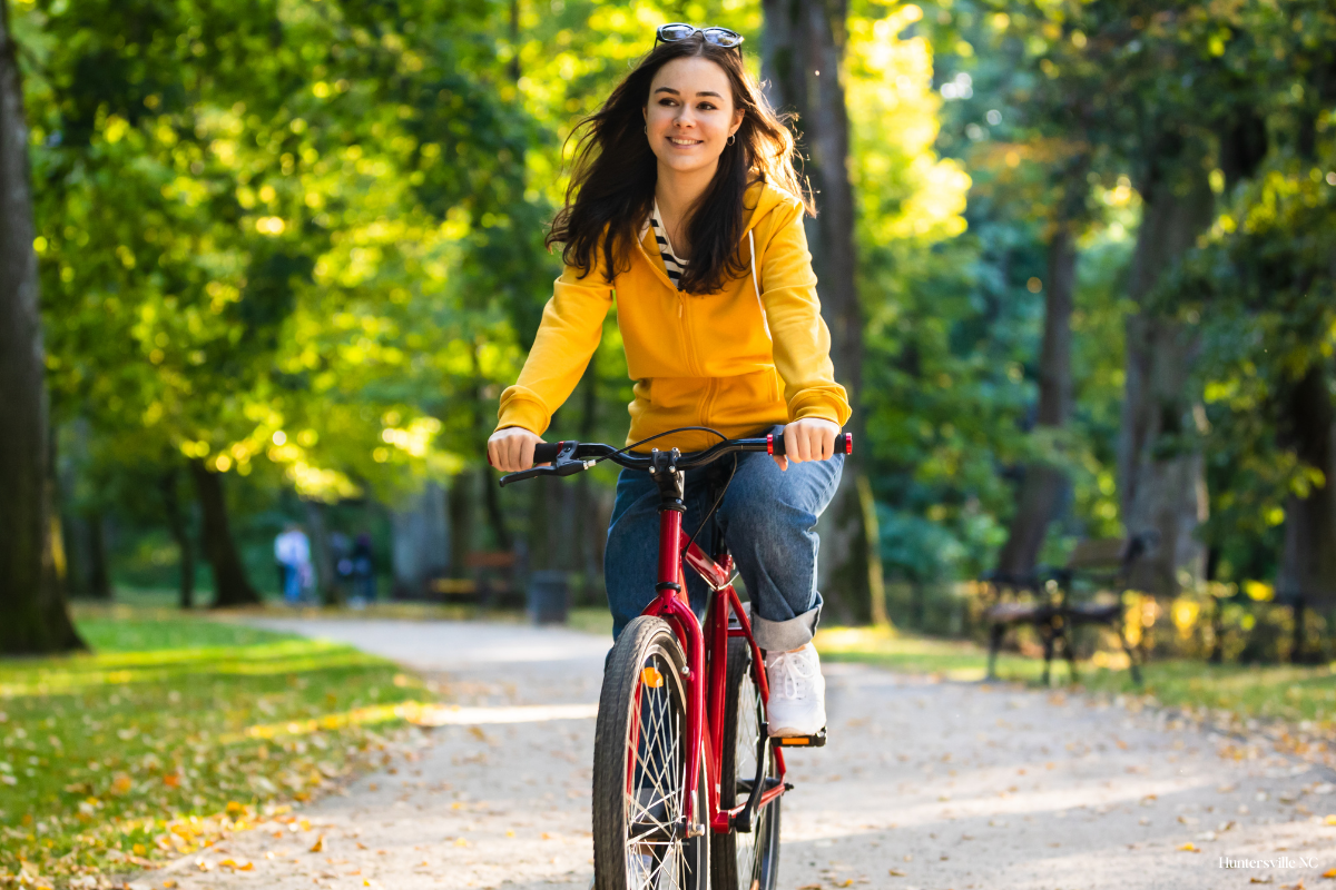 Girl riding a bike along a park trail in Huntersville, North Carolina