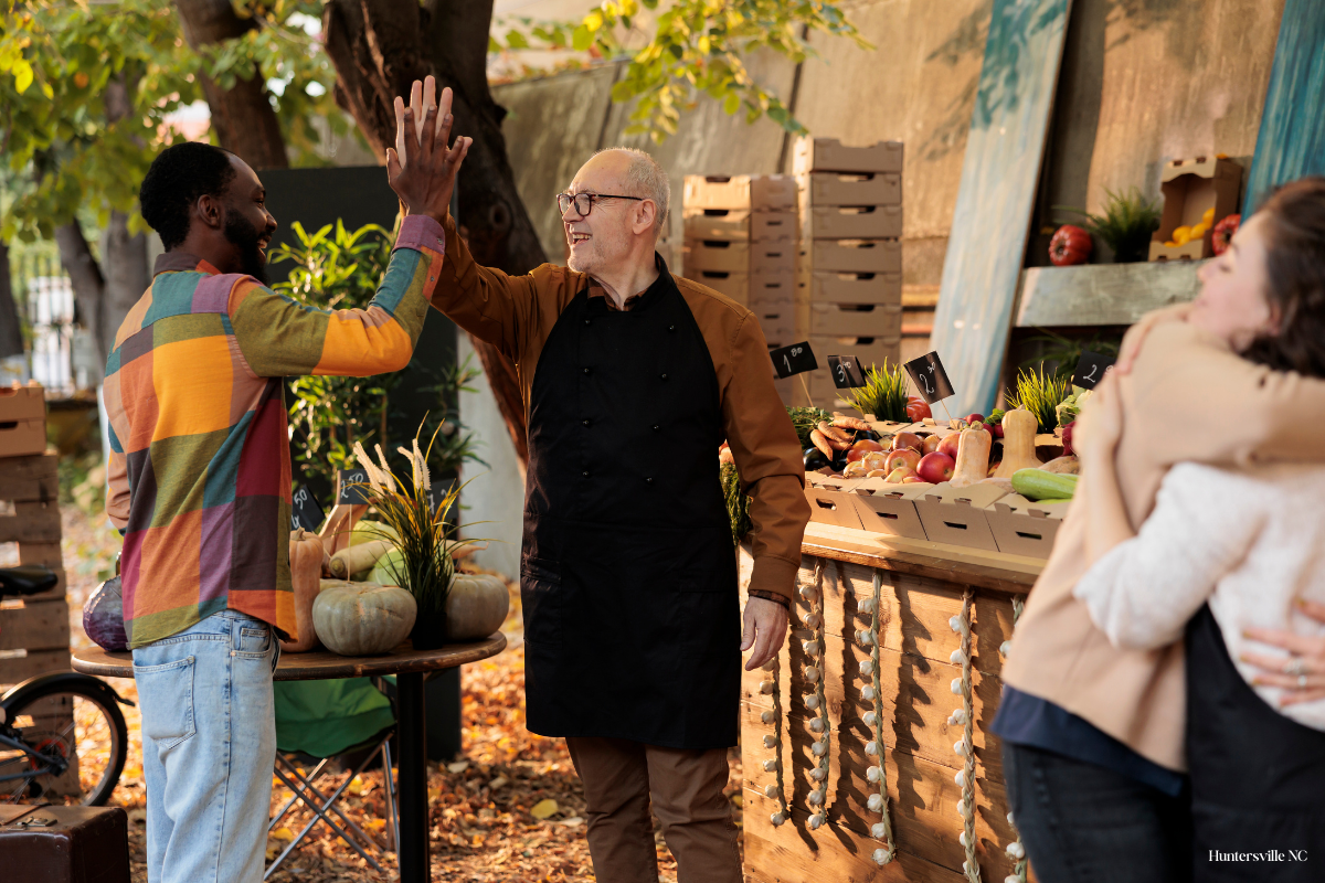 People browsing local vendors at a farmers market in Huntersville, North Carolina