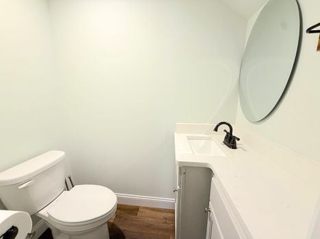Half bathroom with modern vanity and round mirror in nearly new Chester South Carolina home.